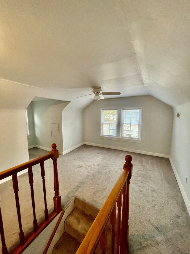 bonus room featuring ceiling fan, carpet flooring, and vaulted ceiling