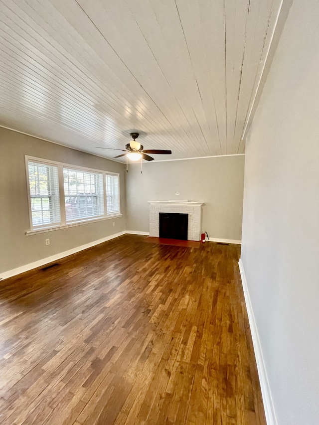 unfurnished living room with wood ceiling, hardwood / wood-style floors, crown molding, a fireplace, and ceiling fan