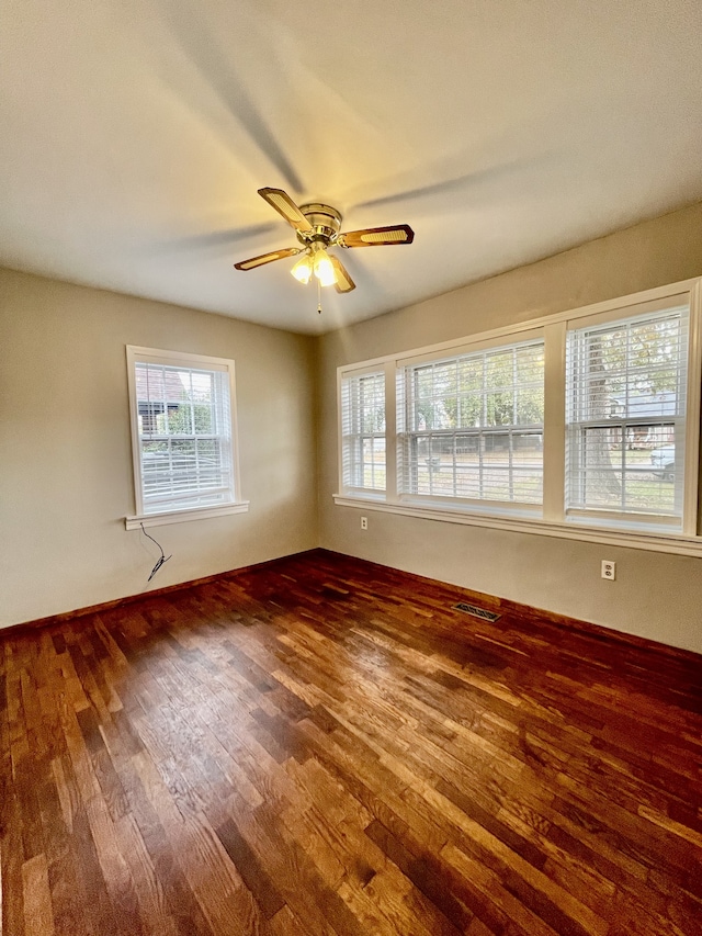 spare room with wood-type flooring and ceiling fan