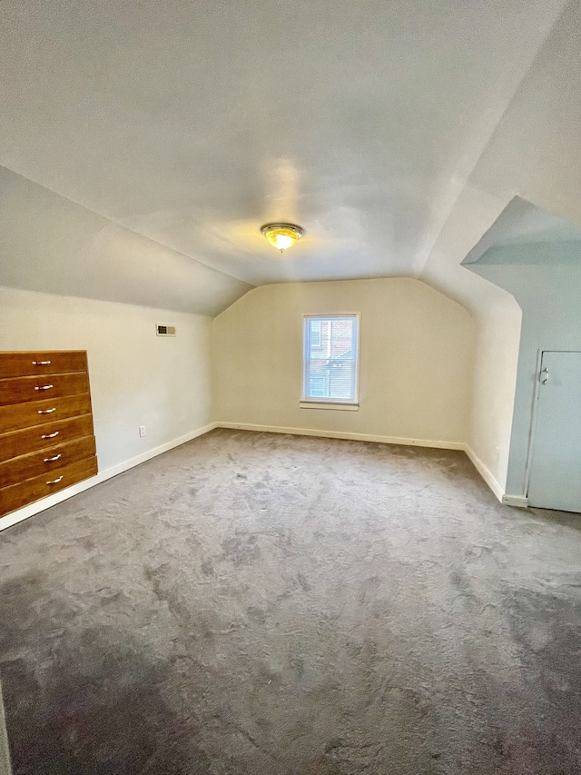 bonus room featuring carpet and vaulted ceiling