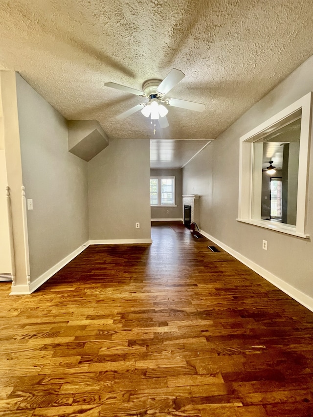 bonus room with hardwood / wood-style flooring and a textured ceiling