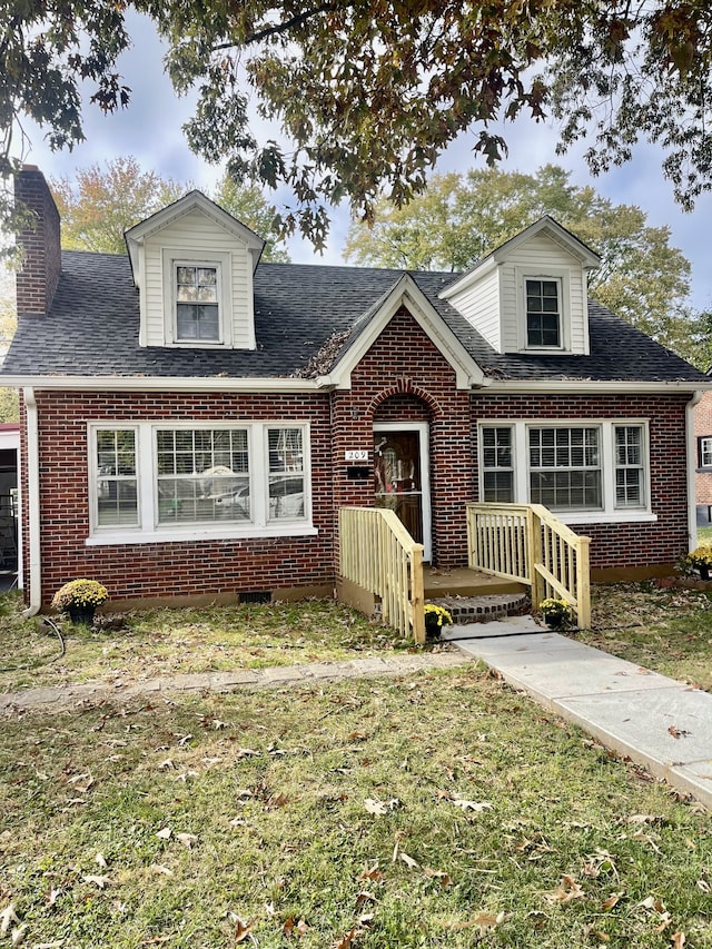 new england style home with a front lawn