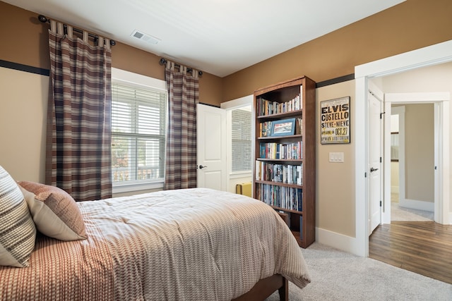 bedroom with hardwood / wood-style floors