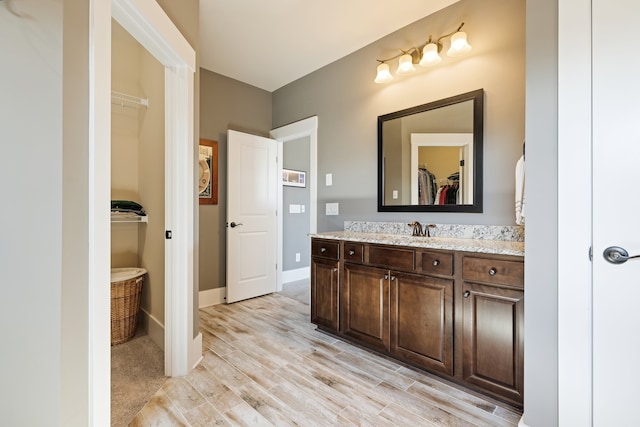 bathroom with vanity and hardwood / wood-style flooring