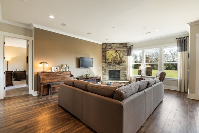 living room with a fireplace, dark hardwood / wood-style flooring, and crown molding