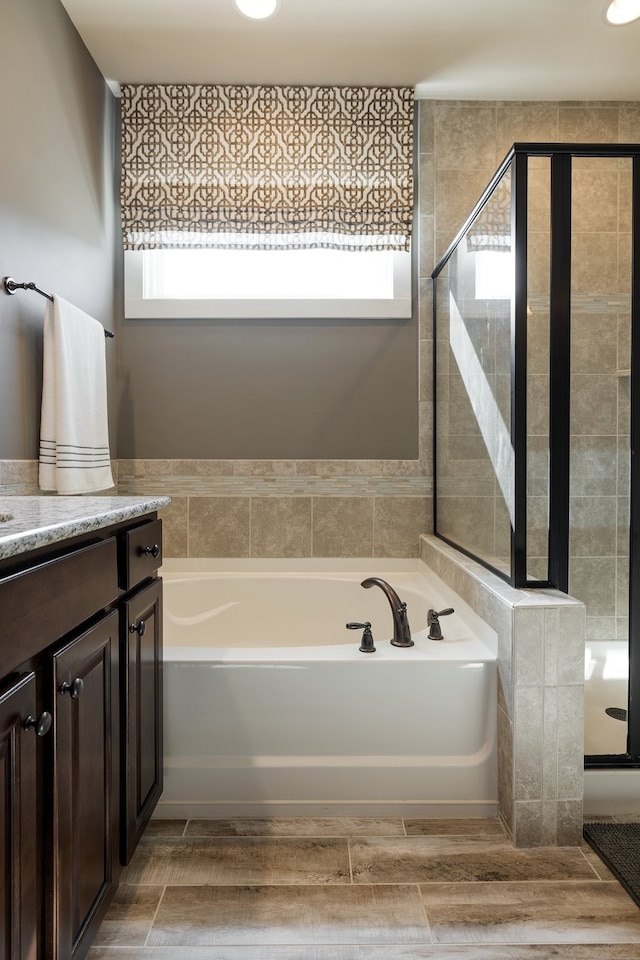 bathroom with plus walk in shower and vanity