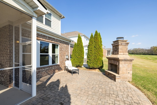 view of patio featuring an outdoor stone fireplace