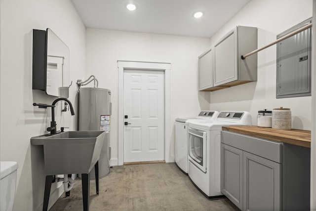 washroom with sink, separate washer and dryer, cabinets, electric water heater, and electric panel