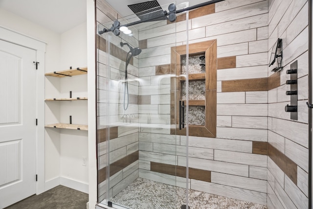 bathroom featuring a shower with door