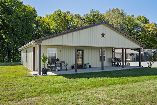 back of property featuring a yard and a patio area