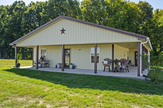 rear view of house with a yard and a patio area