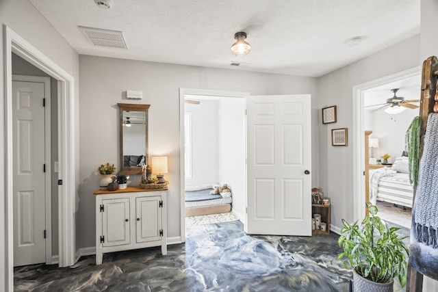 bathroom with a textured ceiling and ceiling fan