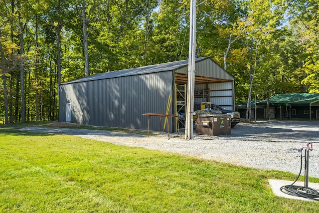 view of outdoor structure featuring a lawn