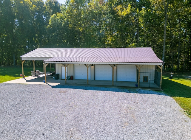 garage featuring a yard and a carport