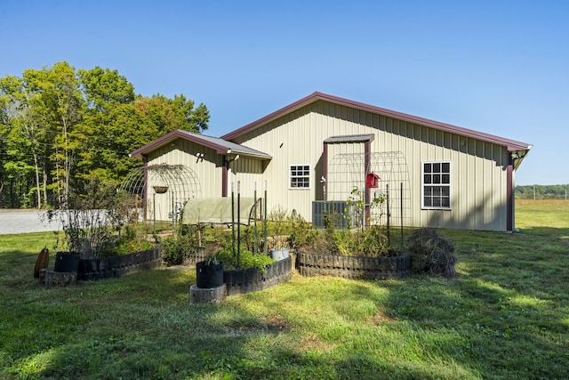 rear view of property with a yard