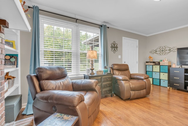 sitting room featuring ornamental molding and light hardwood / wood-style flooring