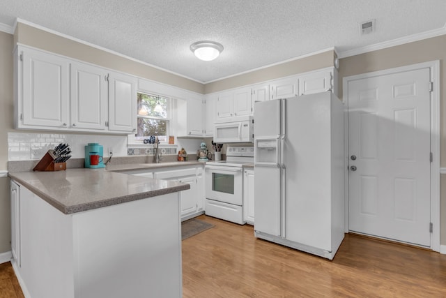 kitchen featuring white cabinetry, kitchen peninsula, light wood-type flooring, and white appliances