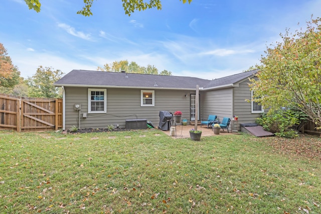 rear view of house featuring a patio area and a yard