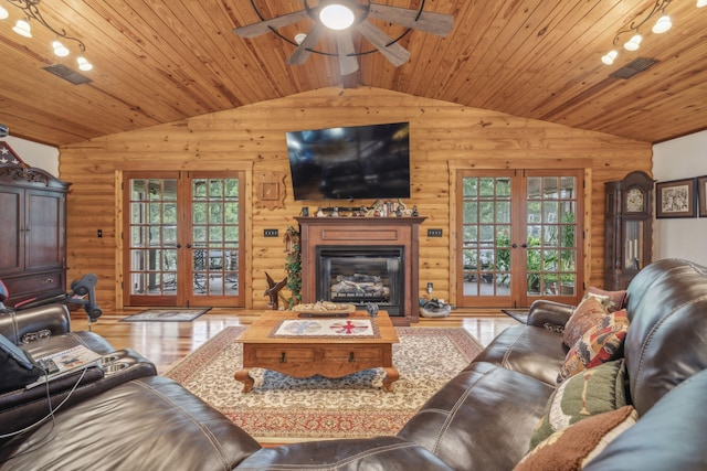 living room featuring french doors, a healthy amount of sunlight, and wood ceiling