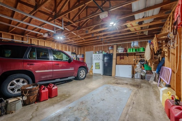 garage featuring a garage door opener and black refrigerator