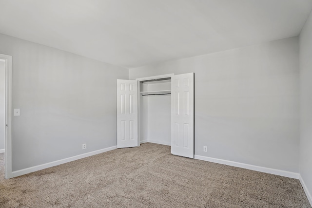 unfurnished bedroom featuring carpet floors and a closet