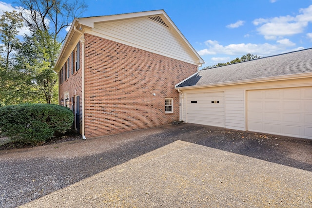 view of side of property with a garage