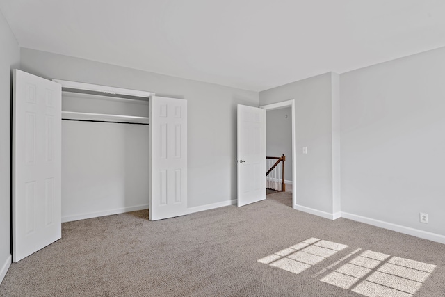 unfurnished bedroom featuring a closet and carpet flooring