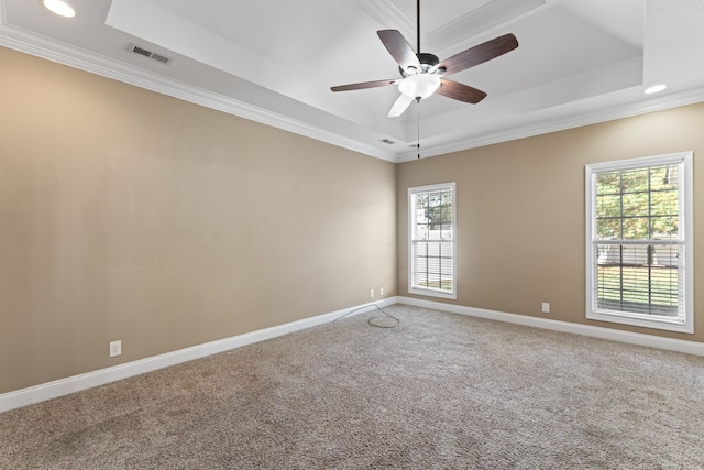 empty room featuring crown molding, carpet floors, a tray ceiling, and ceiling fan