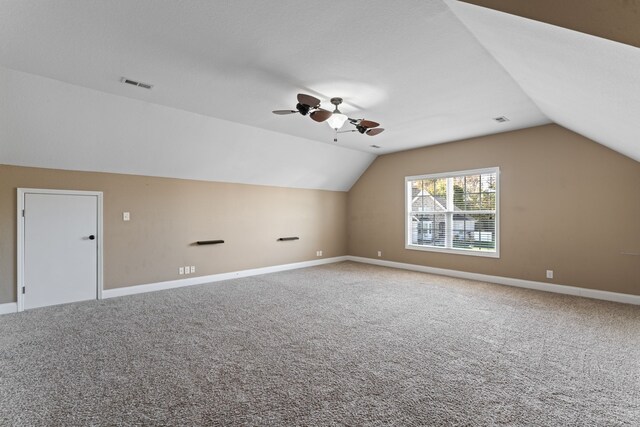 additional living space with lofted ceiling, carpet floors, and ceiling fan