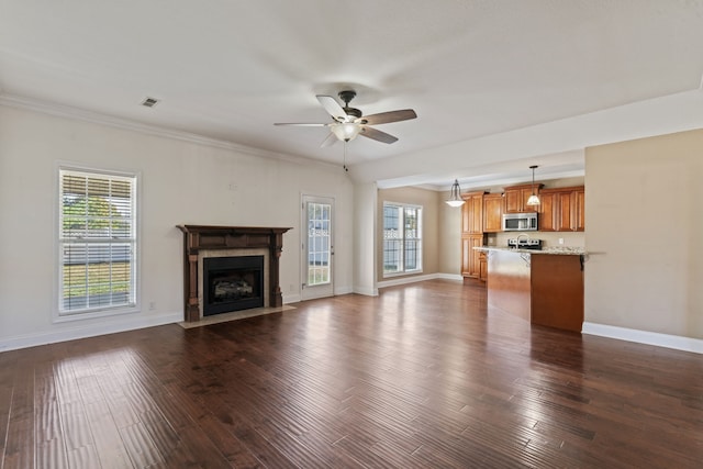 unfurnished living room with ceiling fan, ornamental molding, and dark hardwood / wood-style flooring