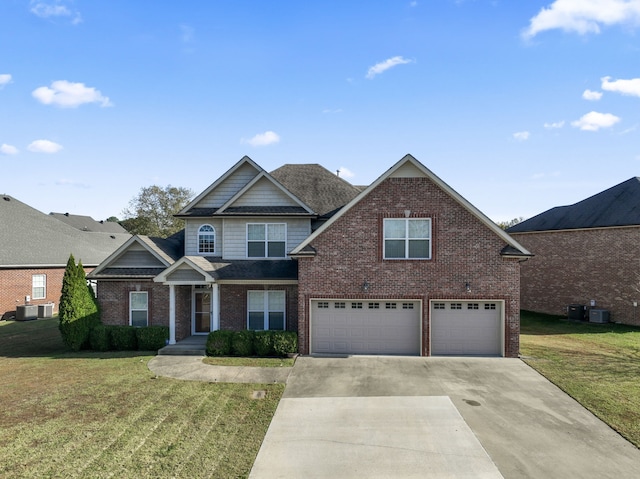 view of front of home featuring a front yard, central AC, and a garage