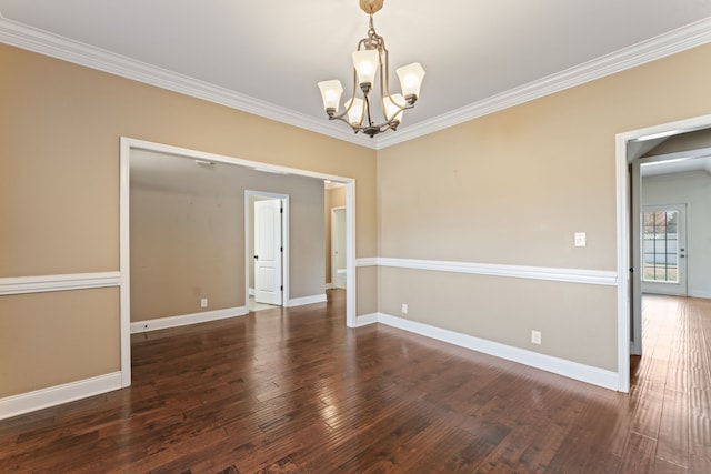 spare room with ornamental molding, a chandelier, and dark hardwood / wood-style floors