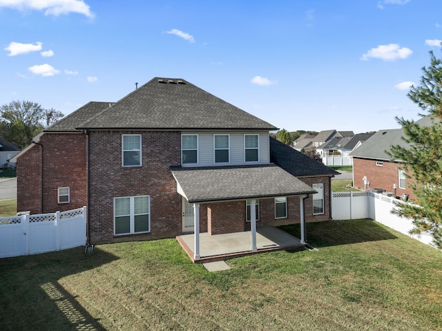 rear view of property with a patio area and a yard