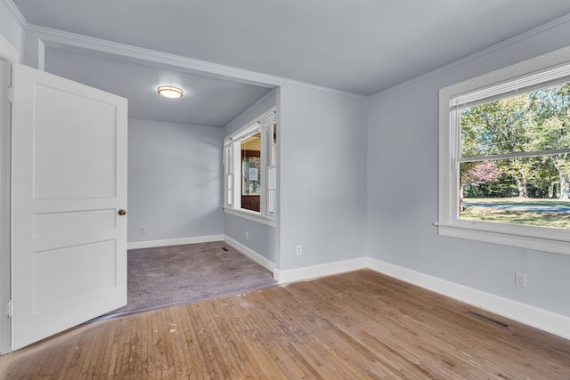 unfurnished room featuring hardwood / wood-style flooring and ornamental molding