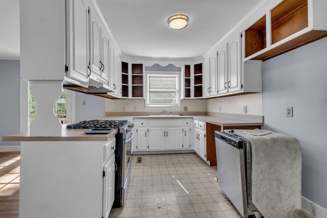 kitchen with white cabinetry, a healthy amount of sunlight, sink, and gas stove