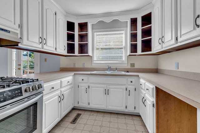 kitchen with sink, white cabinetry, and gas range