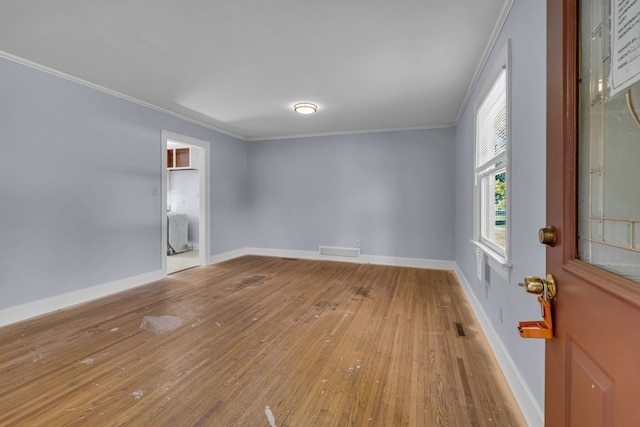 unfurnished room with crown molding and wood-type flooring