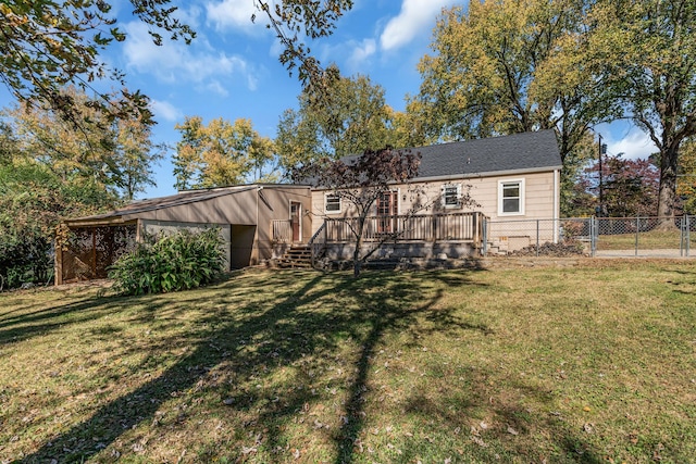 back of house featuring a wooden deck and a yard