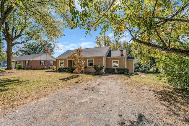 ranch-style home featuring a front yard