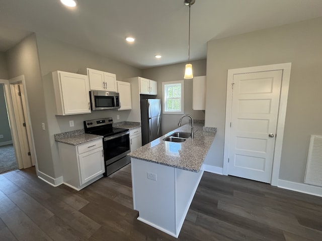 kitchen featuring kitchen peninsula, sink, white cabinets, appliances with stainless steel finishes, and dark hardwood / wood-style flooring