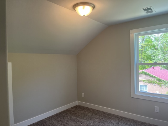 bonus room featuring dark carpet and lofted ceiling