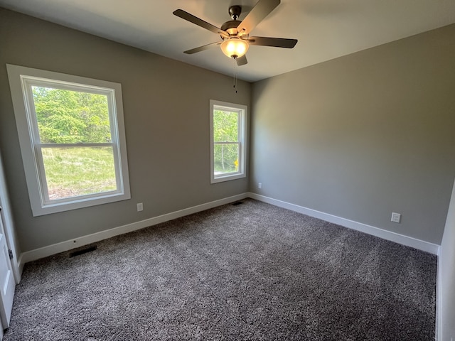 carpeted spare room with ceiling fan