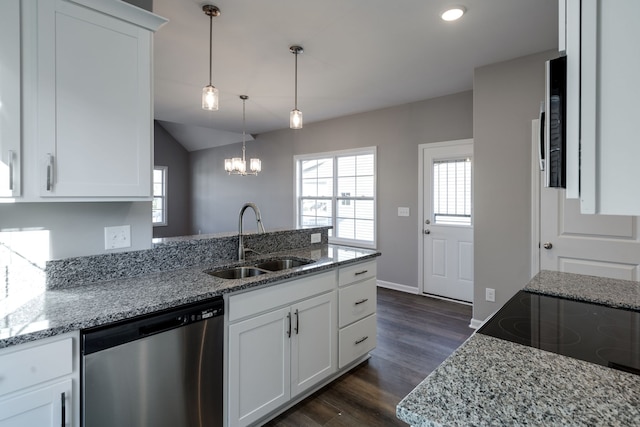 kitchen with white cabinets, sink, stainless steel dishwasher, light stone counters, and dark hardwood / wood-style flooring