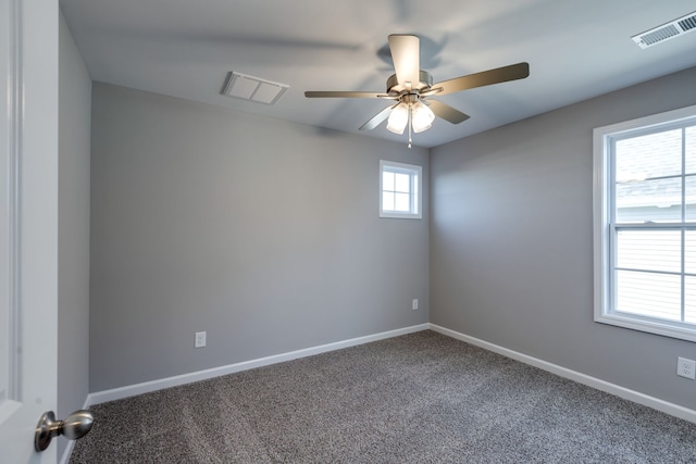 spare room with carpet floors, ceiling fan, and a healthy amount of sunlight