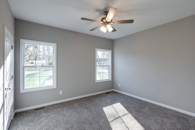 carpeted spare room featuring ceiling fan