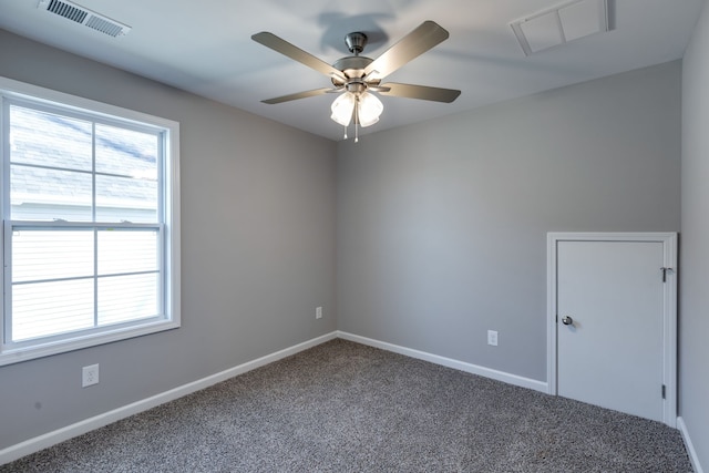 carpeted spare room featuring ceiling fan