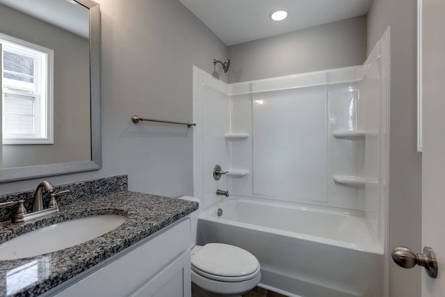 full bathroom featuring bathing tub / shower combination, vanity, and toilet