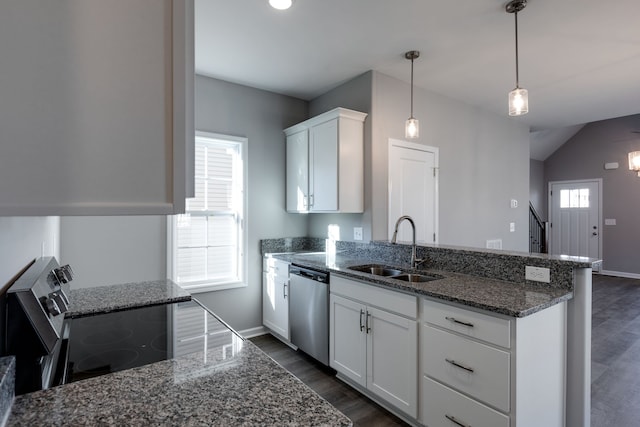 kitchen featuring appliances with stainless steel finishes, sink, decorative light fixtures, white cabinetry, and lofted ceiling