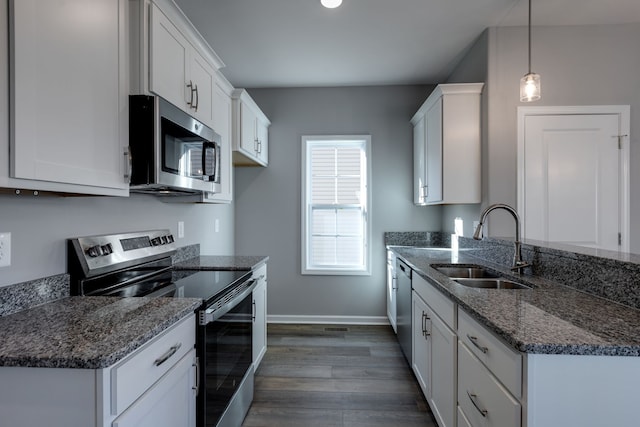 kitchen with white cabinets, decorative light fixtures, dark hardwood / wood-style flooring, and stainless steel appliances