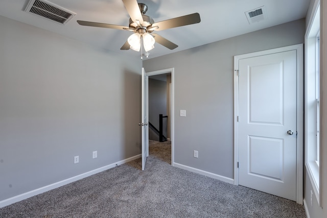 unfurnished bedroom featuring carpet floors and ceiling fan